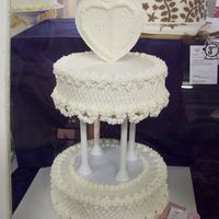 Wedding Cake white wedding cake w/claddagh heart as topper and drop flowers on scrolls around the cake. I picked it out from an old wilton design. i...
