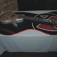Guitar1.jpg guitar cake for graduation. hand cut and painted cake board. I painted his band's logo on the one end. everything is edible except the...