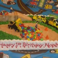 Construction 1/4 sheet yellow cake with BC frosting, crushes oreos for the road and m&m's the figures are store bought.