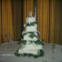 White Square Wedding Cake White cake and red velvet cake, covered in white fondant, with calle lillies and vines.