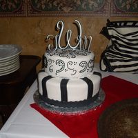 Tara's Wedding Cake 2 tier white cake with black and white fondant, with royal icing piping.