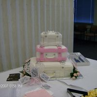 Suitcase 3 tier suit cases for bridal shower. white cake with pink and white fondant