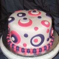 Circle Cake 6" French Vanilla cake filled and iced with buttercream. Covered in fondant with fondant cirlces and balls. I made this for my sisters...