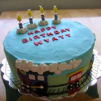 Train Birthday Cake Triple chocolate cake filled and iced with Buttercream Dream. Fondant decorations. For a train loving little boys 4th birthday.