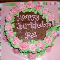 Birthday Cake This cake was done with buttercream icing and royal icing roses for a birthday. I used the ribbon as inspiration in the color scheme.