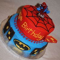 Superhero Cake A cake done with inspiration from several on this site. All buttercream with Hershey bar buildings, fondant windows and superhero logos,...