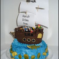 Pirate Ship This was our son's 4th birthday cake. All chocolate except the blue buttercream icing. The bottom is a 10" round with two oval...