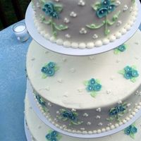Blue Flowers Three Tiered Buttercream frosting with fondant flowers.