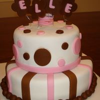 Turning One! For my daughter's First Birthday (and my first cake!). Yellow and chocoalte cake covered in MMF with Wilton rolled fondant accents.