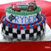 Cars 2 Tier Cake This cake is BC icing with 2 Cars diecast cars on it.