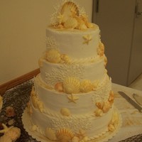 Seashell Wedding Cake Butter cream frosting and white chocolate shells. The coral was piped and allowed to dry before attaching to cake.
