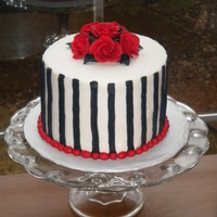 Gothic Roses 6" round cake, frosted with buttercream with black buttercream stripes, and deep red chocolate roses. Made for the cake walk at the...
