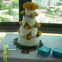 Yellow Roses Wedding Cake Four tier wedding cake with blue satin ribbon & yellow rose