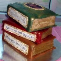 Books.jpg Two layers are chocolate with peanut butter filling, the third is vanilla. Covers and pages done with rolled fondant, the picture on the...