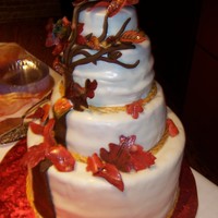 Fall Leaves Wedding Cake This is a fall wedding cake with oak tree symbolic of the couples spiritual life. The leaves are all done in gumpaste and handpainted and...