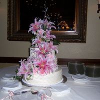 Stargazing On A Quilt This is a 4 tier wedding cake with rhinestones on metal twisted, covered with stargazer lilies coming down the tiers. Each tier is 4 inches...