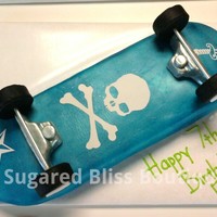 Skull And Crossbones Skateboard Half white and half chocolate cake filled with chocolate mousse and iced in american buttercream icing. Covered in fondant airbrushes in...