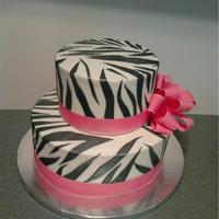 Zebra Stripes With Pink Ribbon butter cream iced cake with black fondant zebra stripes and pink grosgrain ribbon