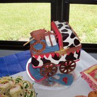 Cowboy Baby Carriage Red Velvet and White Cake with Cream Cheese icing and covered in fondant