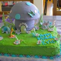Evie's Tinkerbell Forest Tinkerbell cake for my neice's 3rd birthday. All flowers and decorations fondant except for plastic Tinkerbell figure. Main cake iced...