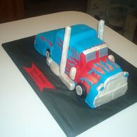 Optimus Prime I sculpted this out of pound cake that I baked using three 9x 5 loaf pans and covered with fondant.