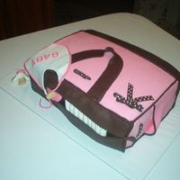 Pink Diaper Bag A two layer 9x13 covered in fondant with fondant diapers, bib and pacifier.