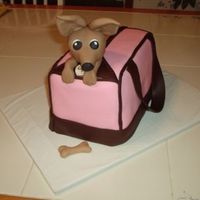 Chihuahua In A Bag The bag is two loaf pans stacked and covered with fondant. The chihuahua head is molded out of fondant.