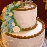 14Th Birthday Cake A simple stacked two tier birthday cake. 14 on top made out of chocolate and dusted with luster dust. Roses made out of vbc frosting....