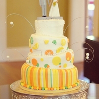 Topsy Turvy Citrus Wedding Cake 6-8-10-12 rounds covered in buttercream with fondant accents. Bobblehead topper was ordered online with the couple. They were having a...