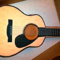 Guitar Grooms Cake Guitar shape carved from two 1/2 sheet cakes stacked. Covered in fondant.
