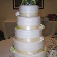 Simple Ivory Wedding Cake 8-10-12-14-16 rounds. All buttercream with satin ribbon and fresh flowers. Biggest cake I have ever made. This beast served around 300 with...
