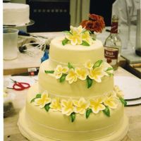 Hawaiian/ Plumeria Wedding Cake Macadamia nut cake. Gum paste plumerias, and rolled Fondant tinted pale yellow. I covered the Cakeboard with rolled Fondant as well.