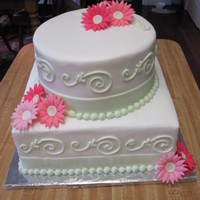 Mixed Shape Bridal Shower Cake With Gerbera Daisy 2 tier cake I made for a bridal shower with gerbera daisy theme. iced in almond buttercream with fondant ribbon and gerbera daisy.