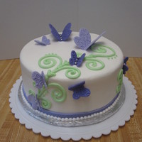 Purple Butterfly Birthday Cake iced in buttercream, fondant butterflies and ribbon