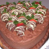 Pict0005.jpg Chocolate Fudge 10" heart cake with chocolate buttercream icing, strawberry whipped cream filling, and chocolate covered strawberries...