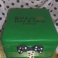 Dallas Gold And Silver Gift Box Gift box rum cake with pineapple filling. MMF frosting. The bow is of fabric. There was an actual wedding ring hidden inside the cake for...