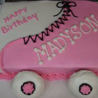 Roller Skate Roller Skate Cake for a 6 yr olds birthday party.Vanilla cake. All buttercream. The wheels are cupcakes.