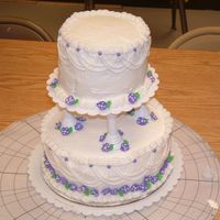 Dscf0059.jpg First tiered cake. It needs some work, but it turned out ok!