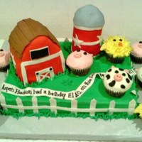 Farmyard Cake 9x13 sheet cake with barn, silo and animal cupcakes. Silo is cake baked in a soup can, bard was carved from a cake cooked in a loaf pan....