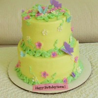 Butterflies And Flowers 8"/6" Buttercream covered with fondant butterflies, flowers and banner.