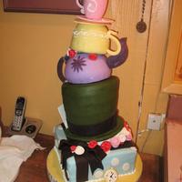 Mad Tea Party.... Five tiers, the top is a sugar mold teacup. There are a few breaks by the time we took the pic, but it was the most ambitious cake yet :)