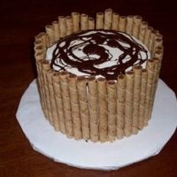 Bday_Cake.jpg This is a cake I made for my mom's birthday. It's a chocolate cake with vanilla buttercream, surrounded by pirouette cookies and...