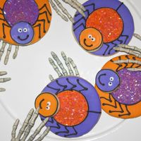 More Happy Spiders Some more spider cookies. This time the spider body has pink sugar crystals and the eyes are white. Royal icing on NFSC.