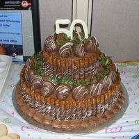 Ultimate Chocolate Fortress Cake Chocolate cake, chocolate buttercream icing and filling. Chocolate covered pretzel rods and strawberries. 50 is made out of chocolate as...