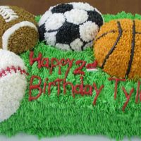 Sports Cake This cake is all buttercream icing. Took forever to do and my hand is aching!
