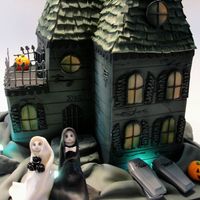 Spooky First Home Cake for a Halloween wedding. House is cake decorated with fondant, chocolate and gumpaste.