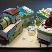 Baby Train This cake was for a baby shower and the cake was patterned after the cute invitations. Each car was a different flavor... TFL!