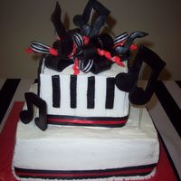 Music ITHIS IS ONLY MY 2ND TEIRED CAKE. I DIDNT USE ENOUGH DOWELS AND THE TOP SANK INTO THE BOTTOM. I ALSO CANT EM TO GET MY EDGES STRAIGHT ON...