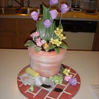 Flower Pot Cake Cake Dimensions2- 6in rounds1- 7in roundCovered in fondant. Lady bug, frog, worm, snail, garden gloves and shovel all made from fondant....