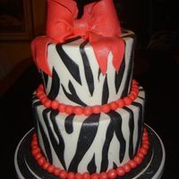 Merideth's Birthday Cake 6,8 inch cakes covered in WBC. Fondant Zebra strips, bow and ball border. Dry dusted with Wilton pearl luster dust. Cake board covered in...